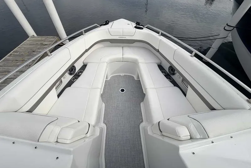 Slide: The Image of 2023 Formula 310 Bowrider I/O boat with spacious white seating and sleek design. - 27
