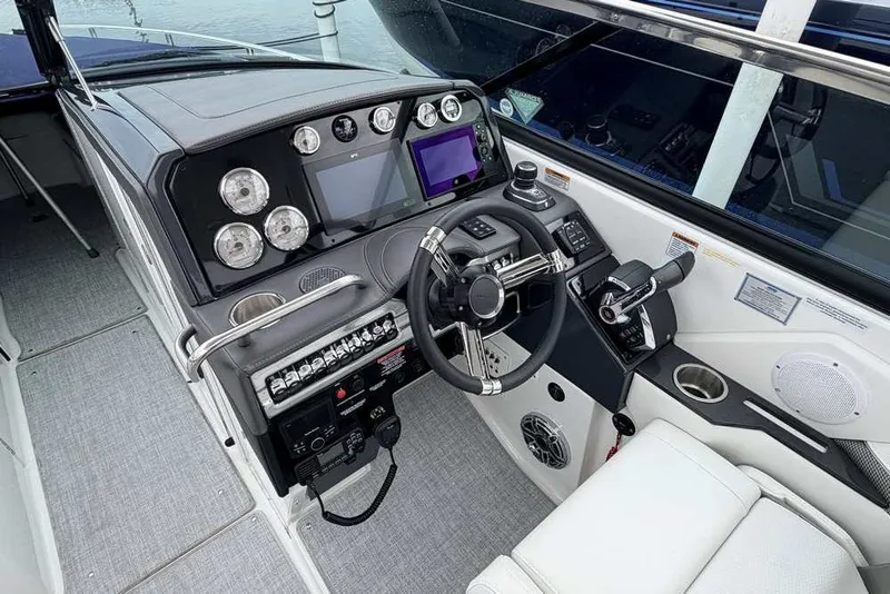 Slide: The Image of Cockpit of 2023 Formula 310 Bowrider I/O with modern controls and navigation system. - 21