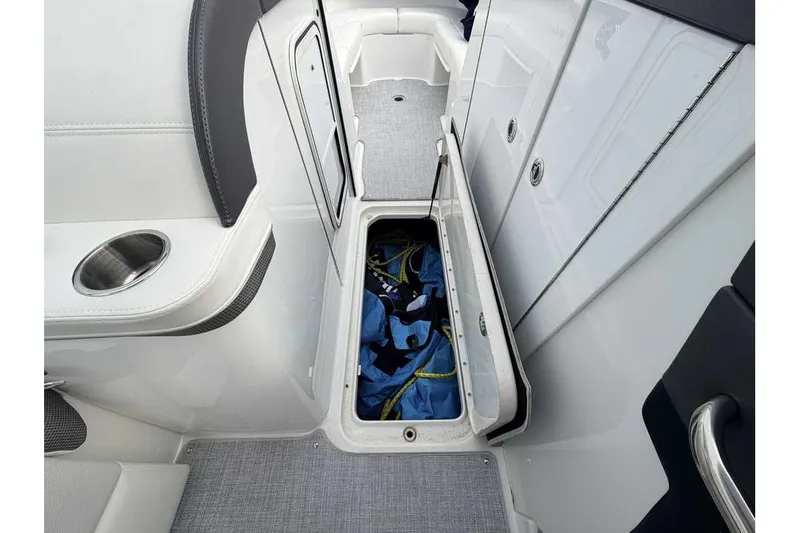 Slide: The Image of 2023 Formula 310 Bowrider I/O interior storage compartment with open hatch and visible gear. - 24