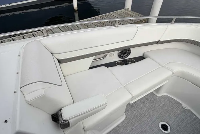 Slide: The Image of 2023 Formula 310 Bowrider I/O boat interior with white seating and cup holders. - 31