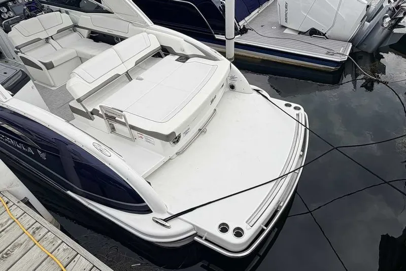Slide: The Image of 2023 Formula 310 Bowrider I/O docked, showcasing spacious seating and sleek design. - 3