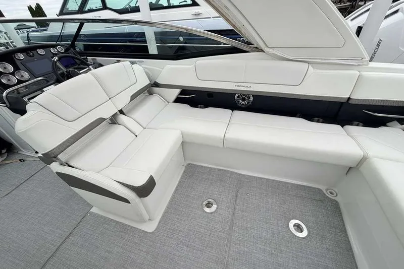 Slide: The Image of 2023 Formula 310 Bowrider I/O interior with luxurious white seating and modern dashboard. - 15