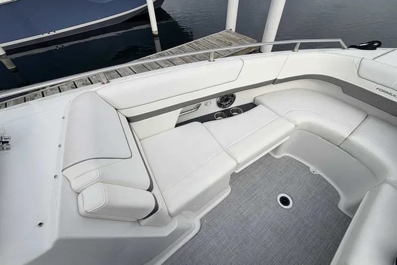 Slide: The Image of 2023 Formula 310 Bowrider I/O boat interior with white seating and gray flooring. - 28