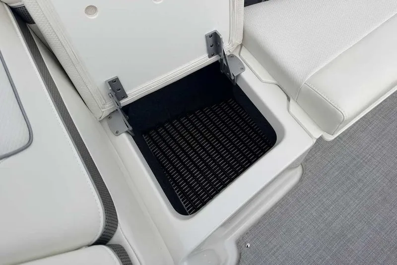 Slide: The Image of 2023 Formula 310 Bowrider I/O storage compartment with open lid and cushioned seating. - 29
