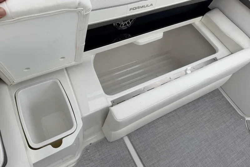 Slide: The Image of 2023 Formula 310 Bowrider I/O boat interior storage compartments and seating area. - 12