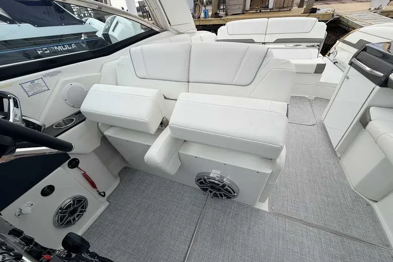 Slide: The Image of 2023 Formula 310 Bowrider I/O interior with white seating and modern design. - 19