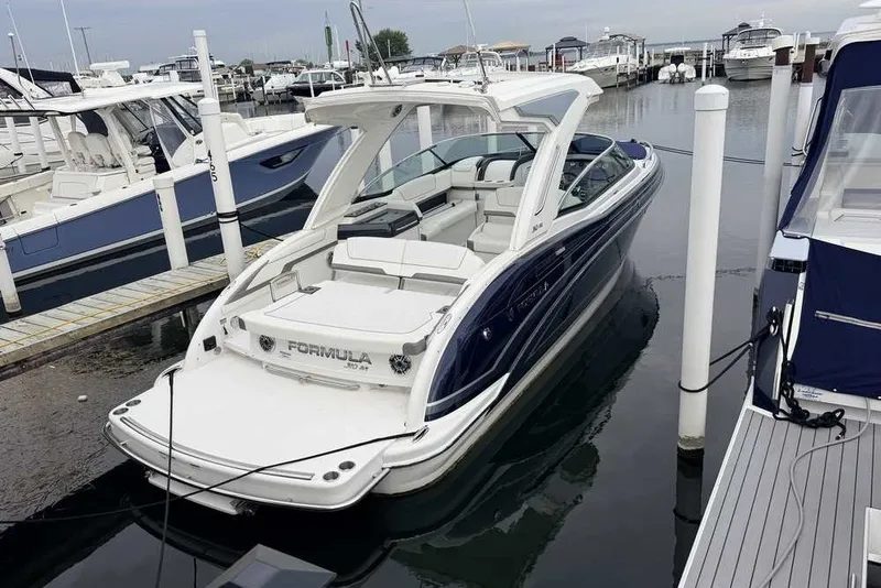 The Image of 2023 Formula 310 Bowrider I/O docked at marina, showcasing sleek design and luxury features. - 1