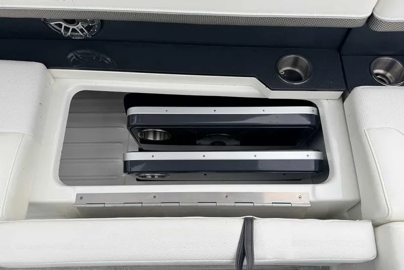 Slide: The Image of 2023 Formula 310 Bowrider I/O boat interior with storage compartment and cup holders. - 17