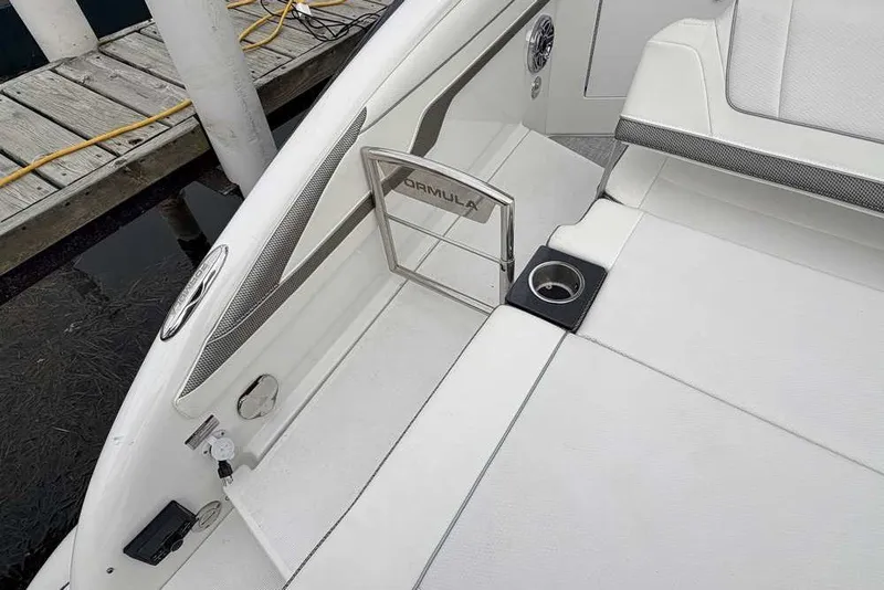 Slide: The Image of 2023 Formula 310 Bowrider I/O boat interior with sleek white seating and cup holder. - 5