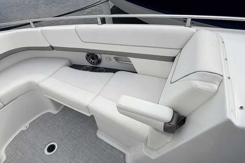 Slide: The Image of 2023 Formula 310 Bowrider I/O boat interior with white seating and cup holders. - 30