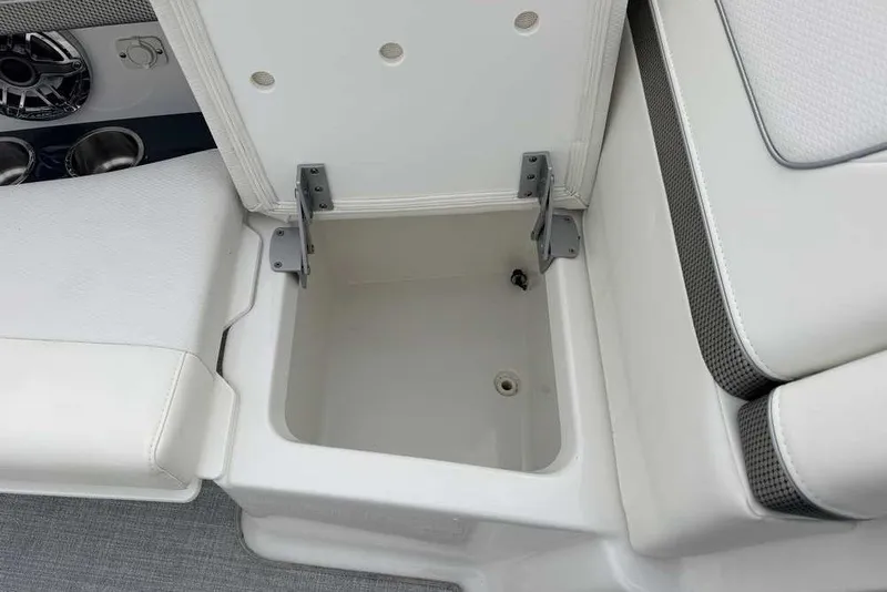 Slide: The Image of 2023 Formula 310 Bowrider I/O storage compartment with cup holders and speaker detail. - 32