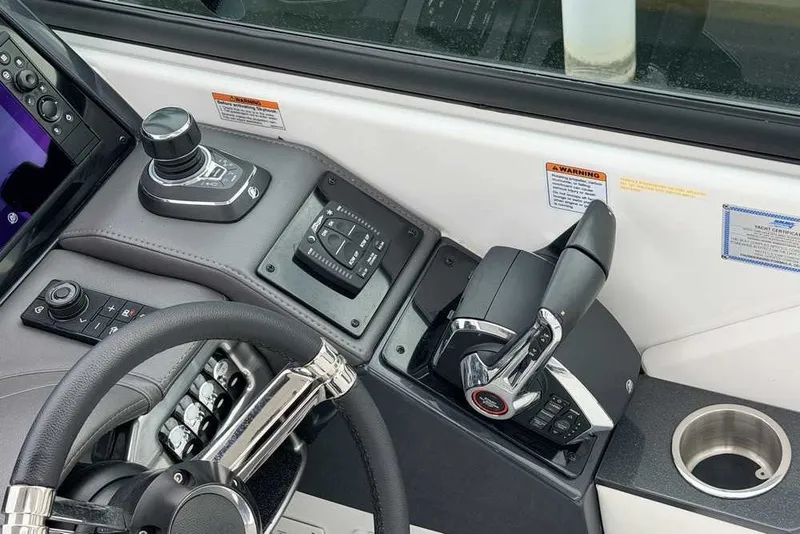 Slide: The Image of 2023 Formula 310 Bowrider I/O helm with joystick, throttle controls, and steering wheel. - 22
