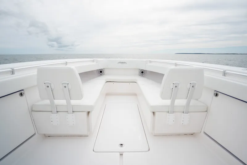 Slide: The Image of 2020 Invincible 39 Open Fisherman boat interior with white seating and ocean view. - 19