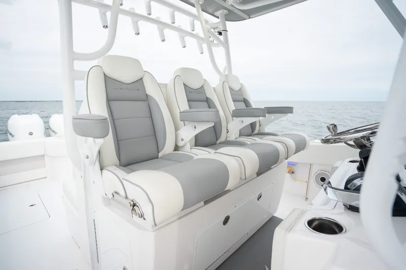 Slide: The Image of Luxurious seating on 2020 Invincible 39 Open Fisherman boat, featuring sleek design and ocean backdrop. - 13