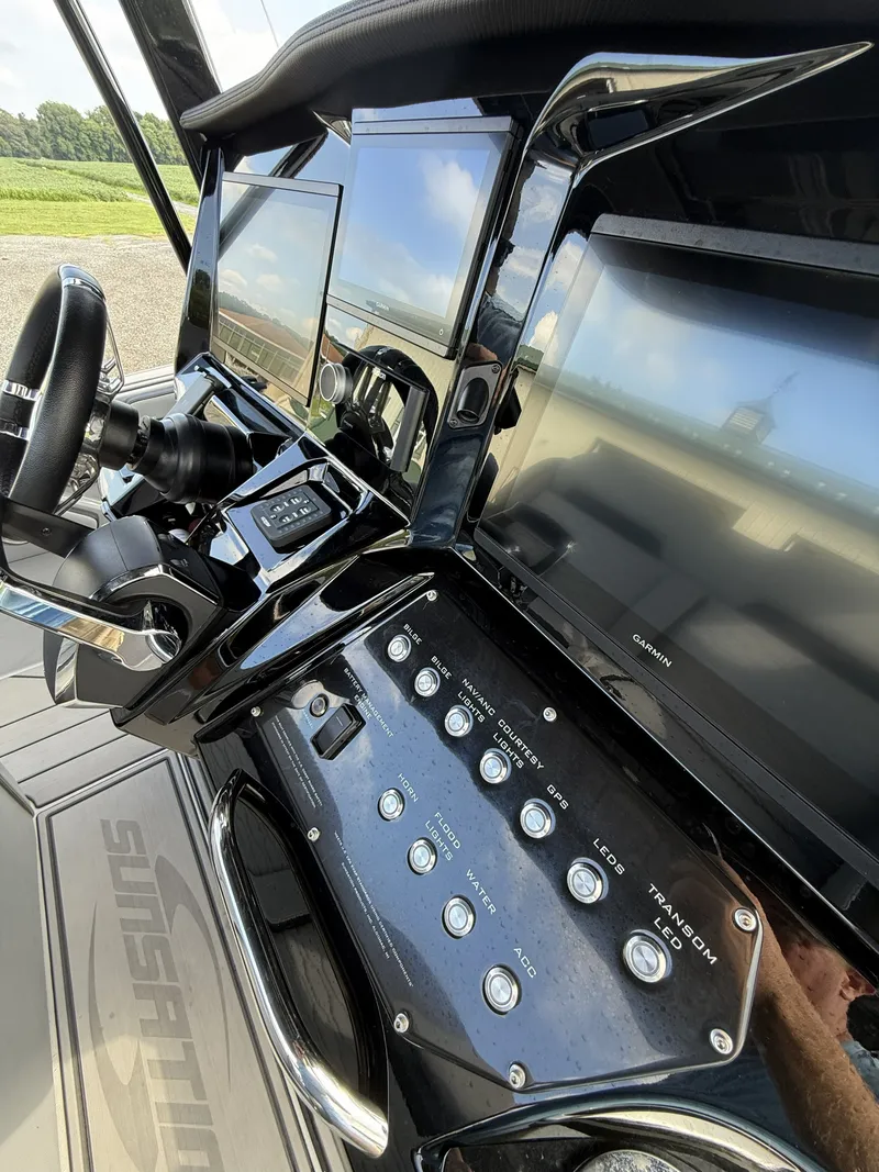 Slide: The Image of The cockpit of the 2024 Sunsation 32 CCX features modern screens and controls with a sleek finish. - 9