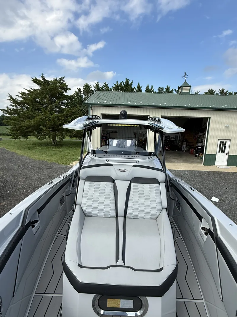 Slide: The Image of The image shows a modern boat with sleek white upholstery and an open deck design. - 5