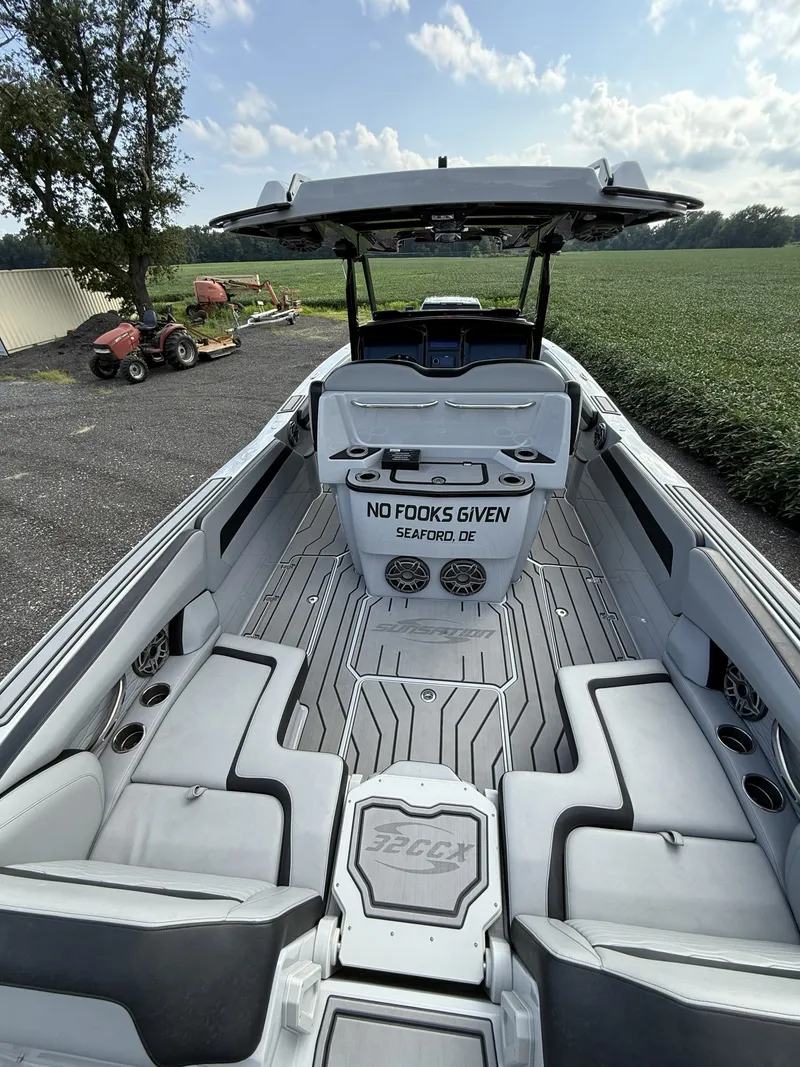 Slide: The Image of The image shows a 2024 Sunsation 32 CCX boat with gray upholstery and a modern helm. - 6
