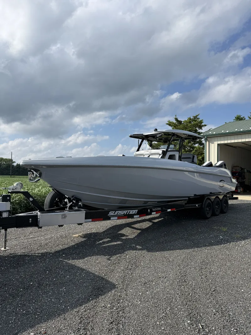 Slide: The Image of A 2024 Sunsation 32 CCX boat on a trailer, ready for transport. - 1
