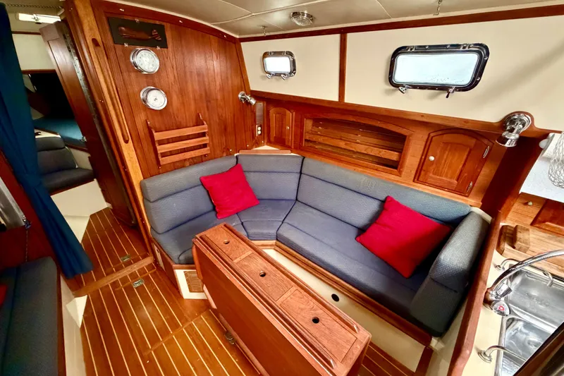 Slide: The Image of Interior of 1997 Pacific Seacraft Crealock 37 sailboat with cozy seating and wooden accents. - 53