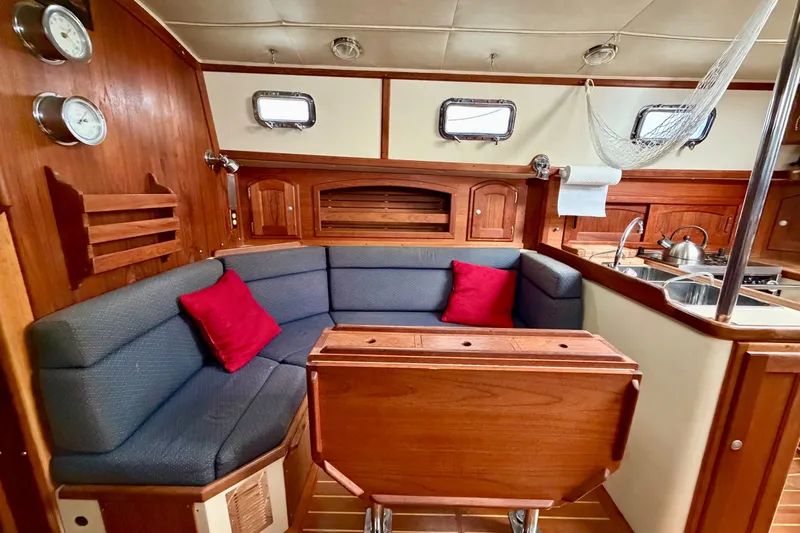 Slide: The Image of Interior of 1997 Pacific Seacraft Crealock 37 sailboat with cozy seating and wooden finishes. - 52