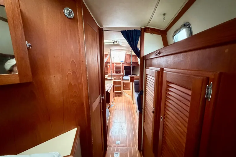 Slide: The Image of Interior of 1997 Pacific Seacraft Crealock 37 sailboat with wooden cabinetry and flooring. - 79