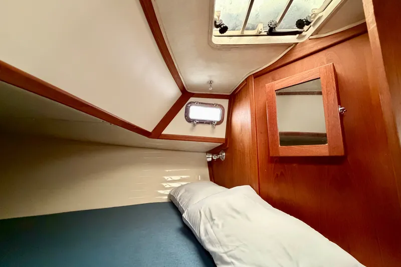 Slide: The Image of Cozy cabin interior of 1997 Pacific Seacraft Crealock 37 sailboat with wooden accents. - 70