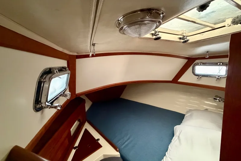 Slide: The Image of Cozy cabin interior of 1997 Pacific Seacraft Crealock 37 sailboat with portholes and bedding. - 71