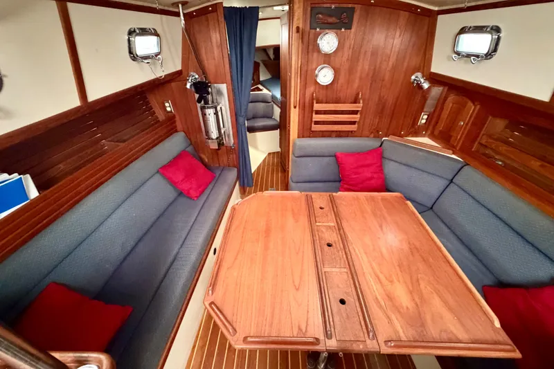 Slide: The Image of Interior of 1997 Pacific Seacraft Crealock 37 sailboat with wooden table and seating. - 56