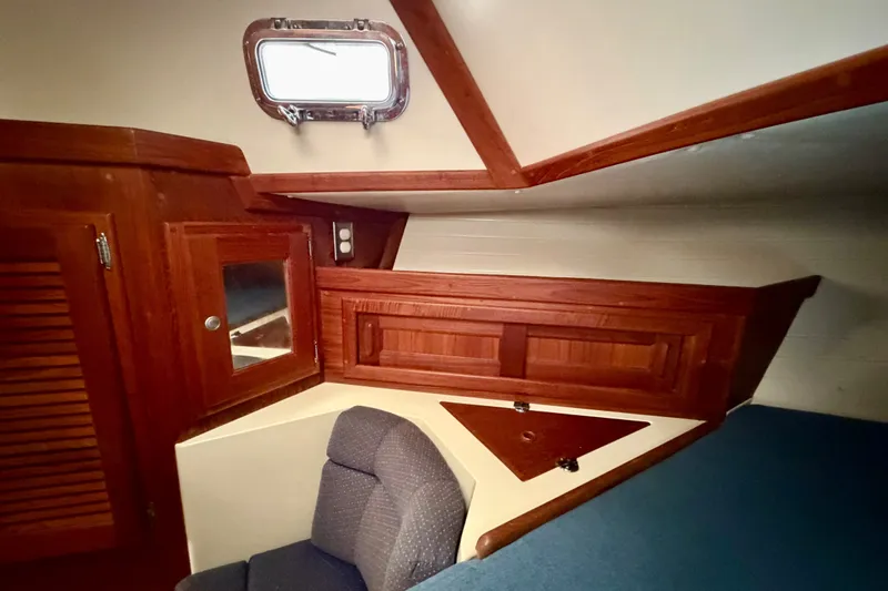 Slide: The Image of Interior of 1997 Pacific Seacraft Crealock 37 sailboat with wooden cabinetry and seating. - 76