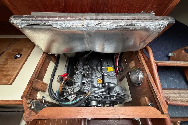 Slide: The Image of Engine compartment of a 1997 Pacific Seacraft Crealock 37 sailboat, showcasing detailed mechanics. - 37