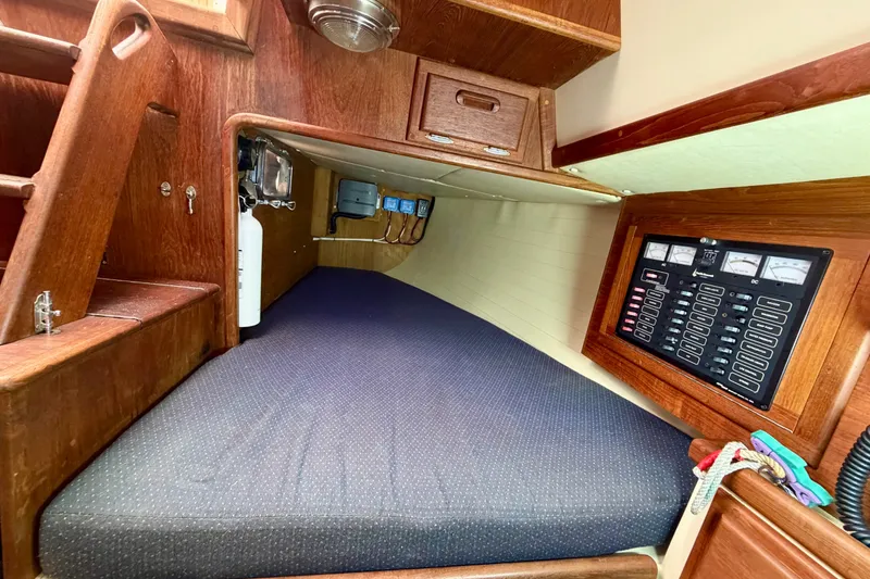 Slide: The Image of Cozy cabin interior of 1997 Pacific Seacraft Crealock 37 sailboat with control panel. - 44