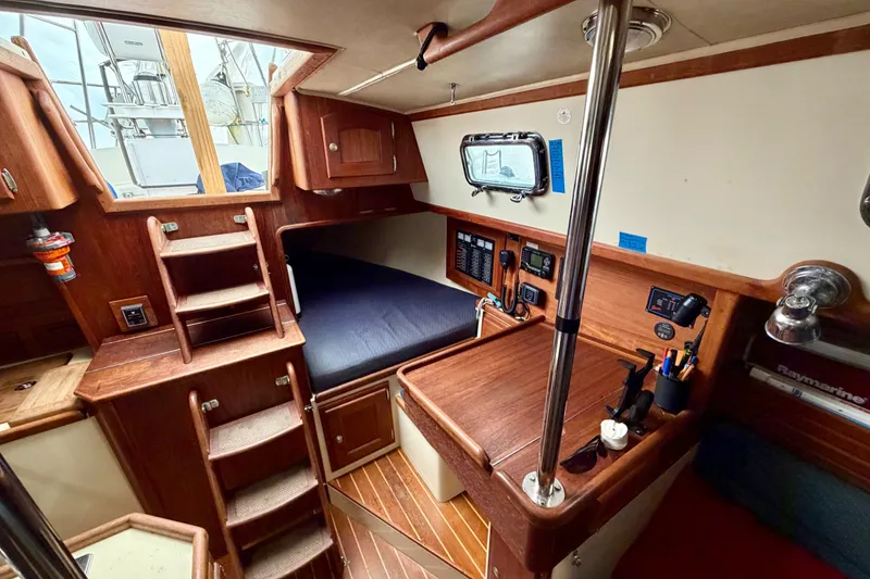 Slide: The Image of Interior of 1997 Pacific Seacraft Crealock 37 sailboat with wooden cabinetry and navigation station. - 20