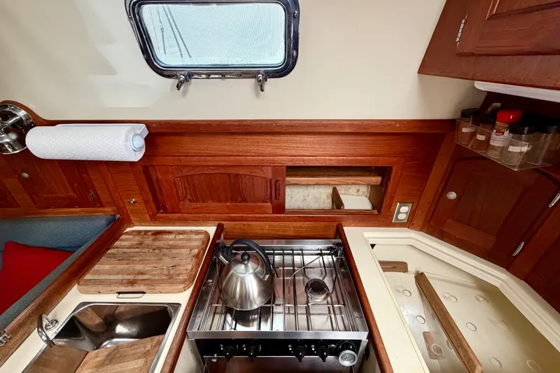 Slide: The Image of Cozy galley kitchen in 1997 Pacific Seacraft Crealock 37 sailboat with stove and sink. - 30