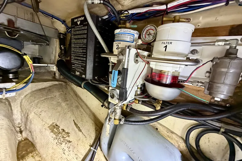 Slide: The Image of Engine compartment of a 1997 Pacific Seacraft Crealock 37, featuring dual fuel filters and wiring. - 43