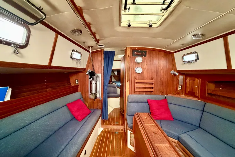 Slide: The Image of Interior of 1997 Pacific Seacraft Crealock 37 sailboat with cozy seating and wooden finishes. - 48