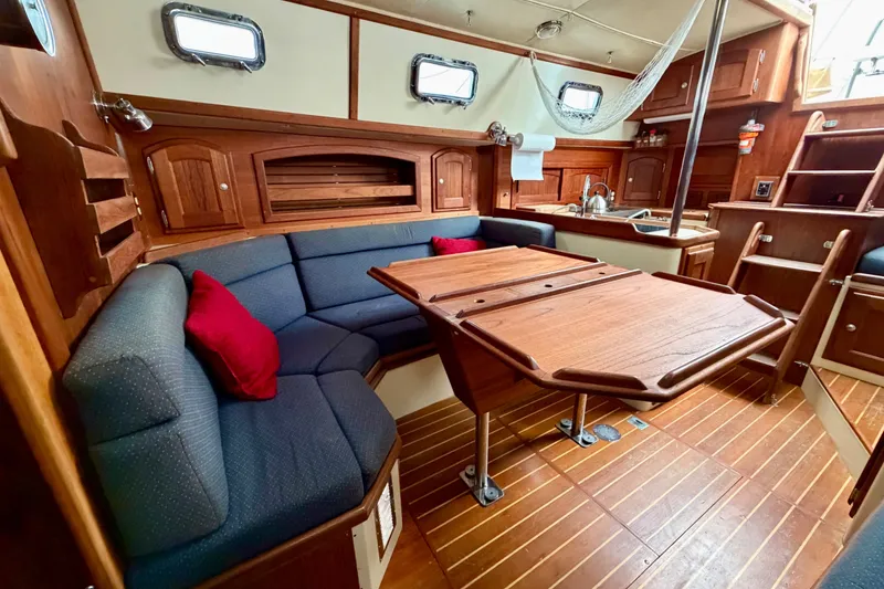 Slide: The Image of Interior of 1997 Pacific Seacraft Crealock 37 sailboat with wooden furnishings and cozy seating. - 57
