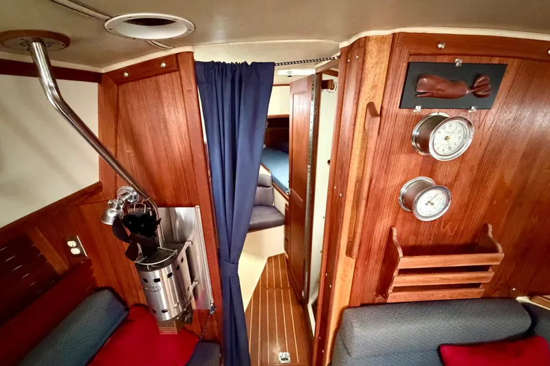 Slide: The Image of Interior of 1997 Pacific Seacraft Crealock 37 sailboat with wood paneling and nautical decor. - 58