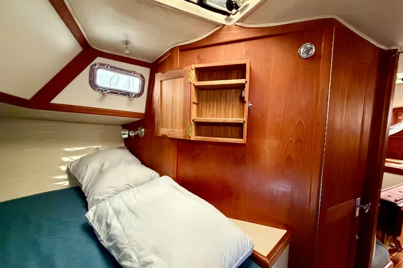 Slide: The Image of Cozy cabin interior of 1997 Pacific Seacraft Crealock 37 sailboat with wooden cabinetry. - 77