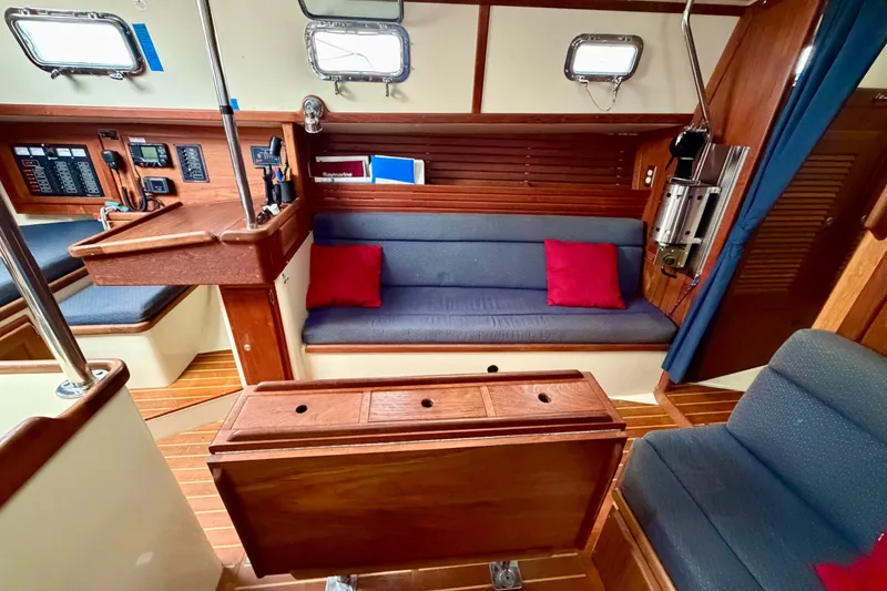 Slide: The Image of Interior of 1997 Pacific Seacraft Crealock 37 sailboat with blue seating and wooden accents. - 55
