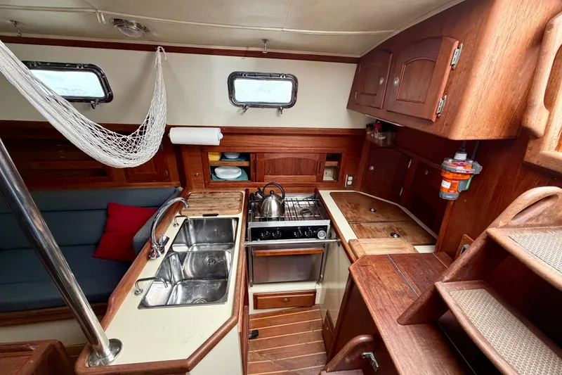 Slide: The Image of Interior of 1997 Pacific Seacraft Crealock 37 sailboat with kitchen and seating area. - 21