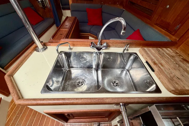 Slide: The Image of Galley sink in 1997 Pacific Seacraft Crealock 37 yacht interior with wood accents. - 32