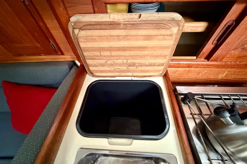 Slide: The Image of Galley area of 1997 Pacific Seacraft Crealock 37 sailboat with wooden cabinetry and sink. - 33