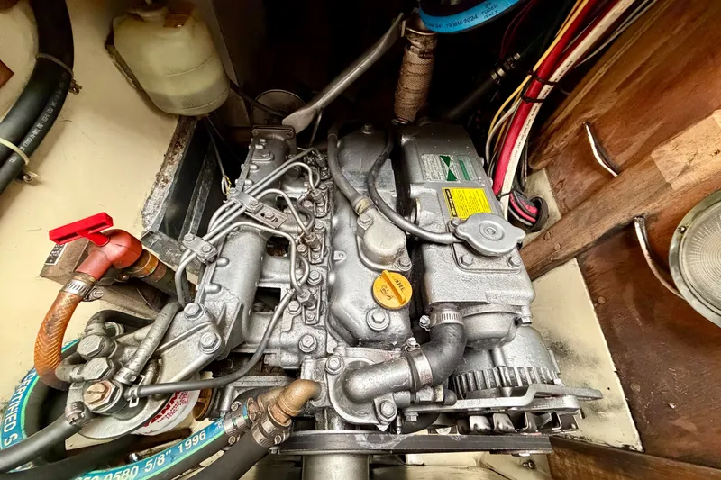 Slide: The Image of Engine compartment of a 1997 Pacific Seacraft Crealock 37 sailboat, showcasing detailed mechanical components. - 38