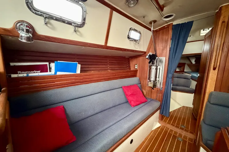 Slide: The Image of Interior of 1997 Pacific Seacraft Crealock 37 sailboat with cozy seating and nautical decor. - 49