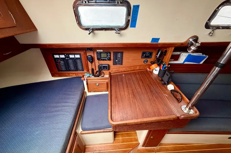 Slide: The Image of Interior of 1997 Pacific Seacraft Crealock 37 sailboat with navigation station and seating area. - 16