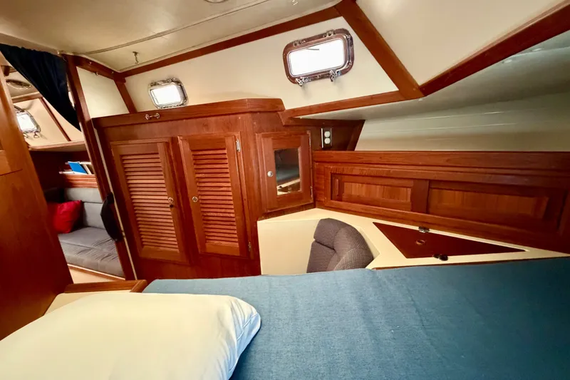 Slide: The Image of Interior of 1997 Pacific Seacraft Crealock 37 sailboat with wooden cabinetry and cozy seating. - 74