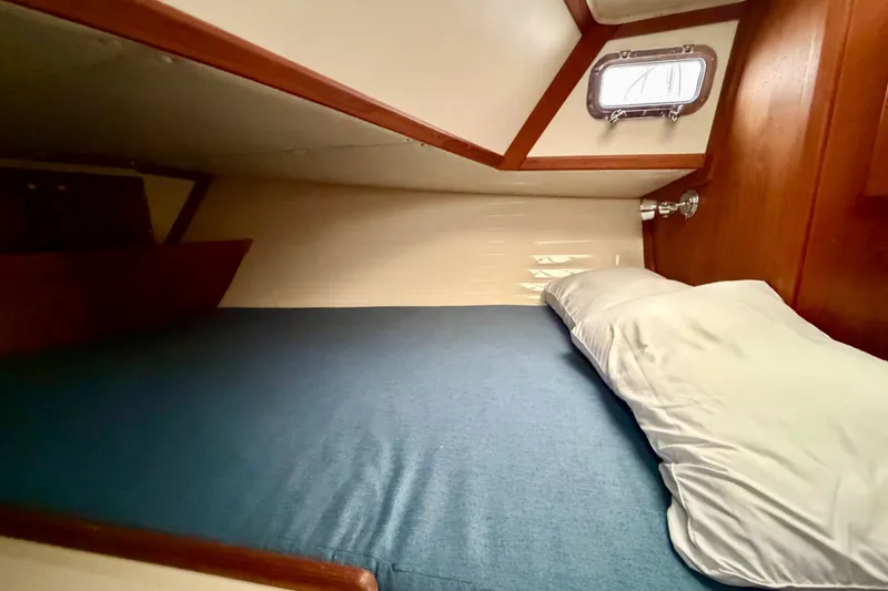 Slide: The Image of Cozy cabin interior of 1997 Pacific Seacraft Crealock 37 sailboat with blue bedding. - 69