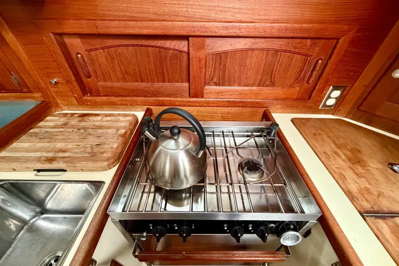 Slide: The Image of Galley kitchen of 1997 Pacific Seacraft Crealock 37 with stove and kettle. - 23