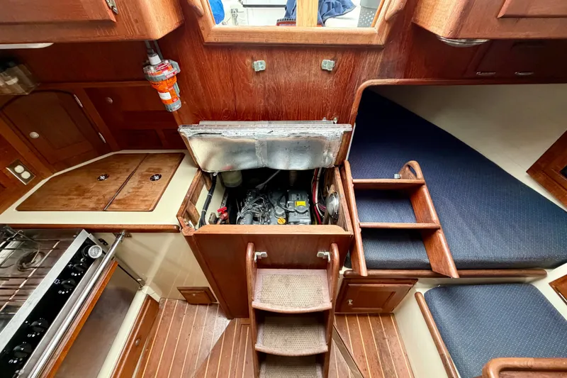 Slide: The Image of Interior of 1997 Pacific Seacraft Crealock 37 sailboat showing engine compartment and wooden cabinetry. - 36