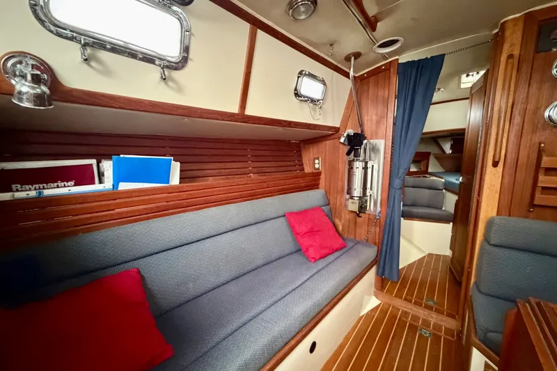 Slide: The Image of Interior of 1997 Pacific Seacraft Crealock 37 sailboat with cozy seating and wooden accents. - 50